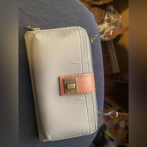 Saks crossbody/clutch. Holds phone. I used it while traveling and it was great.